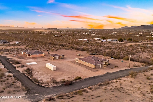 aerial view at dusk featuring a mountain view