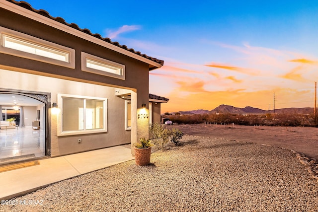 exterior space with a mountain view and a patio area