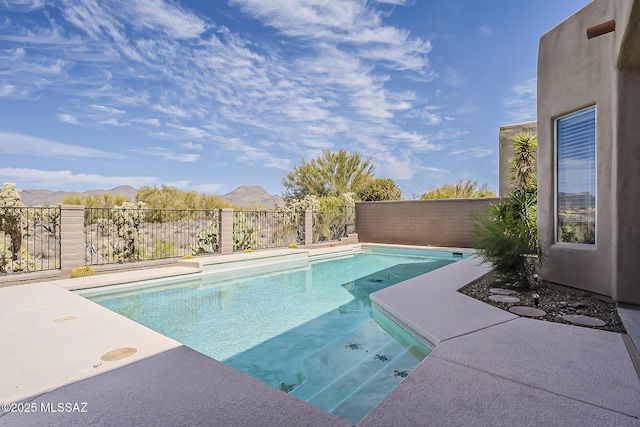 view of pool with a fenced in pool, fence, and a mountain view