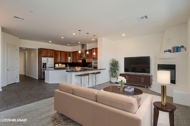 living area featuring recessed lighting and visible vents