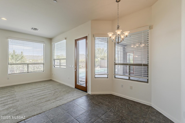 interior space with dark colored carpet, visible vents, baseboards, and a chandelier