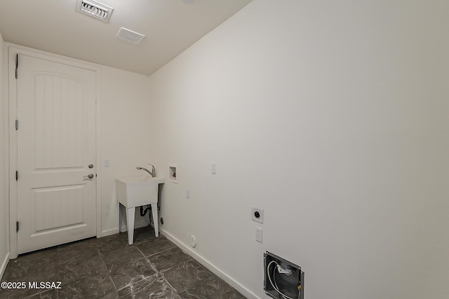 laundry room with laundry area, hookup for a washing machine, electric dryer hookup, and visible vents