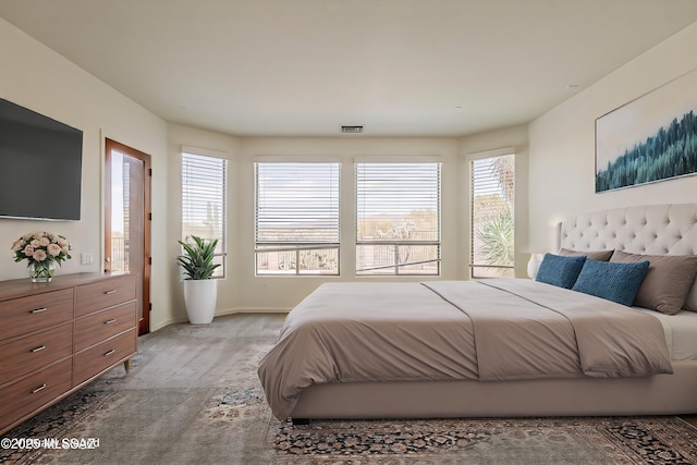 bedroom featuring visible vents and baseboards