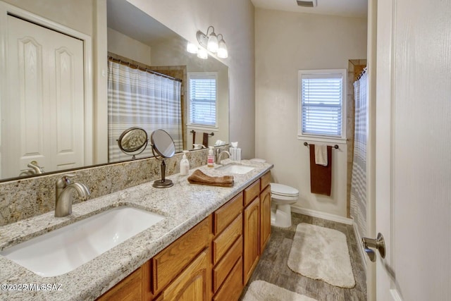 bathroom with vanity, a shower with shower curtain, and toilet