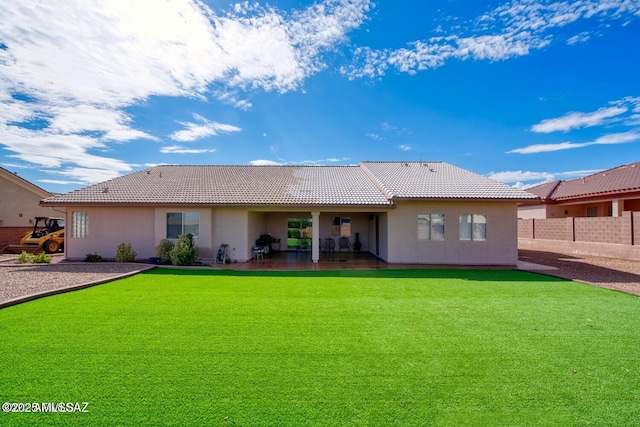 rear view of property featuring a yard