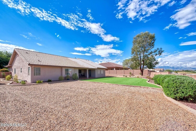 back of property with a lawn