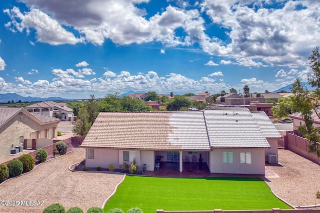 exterior space with a mountain view, a yard, and cooling unit