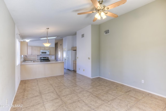 kitchen featuring lofted ceiling, sink, white appliances, light brown cabinetry, and kitchen peninsula