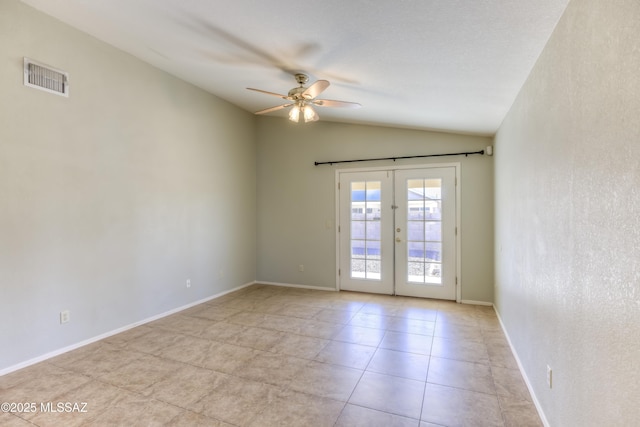 empty room featuring vaulted ceiling, ceiling fan, and french doors