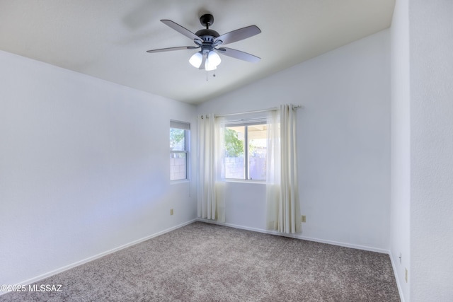 carpeted empty room with vaulted ceiling and ceiling fan