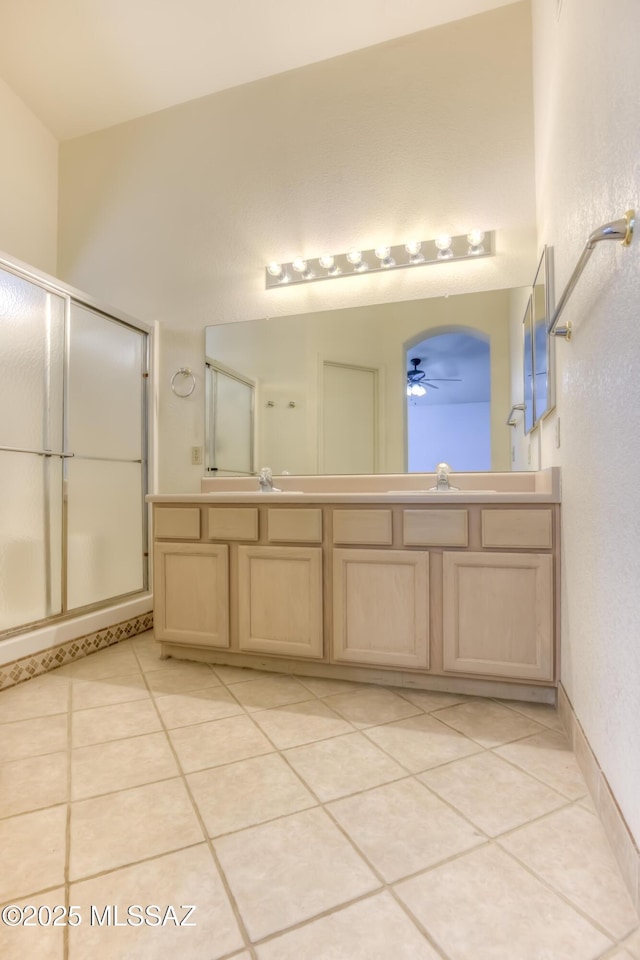 bathroom with vanity, a shower with shower door, tile patterned floors, and ceiling fan