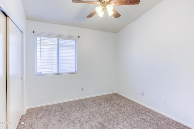 carpeted spare room with ceiling fan