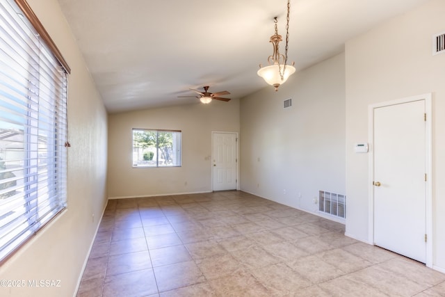 tiled empty room with lofted ceiling and ceiling fan