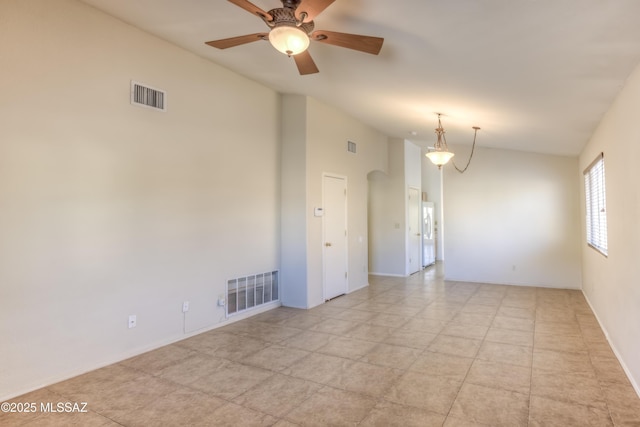 spare room featuring vaulted ceiling and ceiling fan