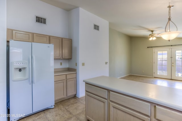 kitchen featuring ceiling fan, hanging light fixtures, white refrigerator with ice dispenser, light brown cabinetry, and french doors