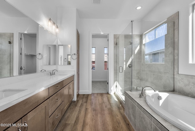 bathroom featuring hardwood / wood-style floors, separate shower and tub, and vanity
