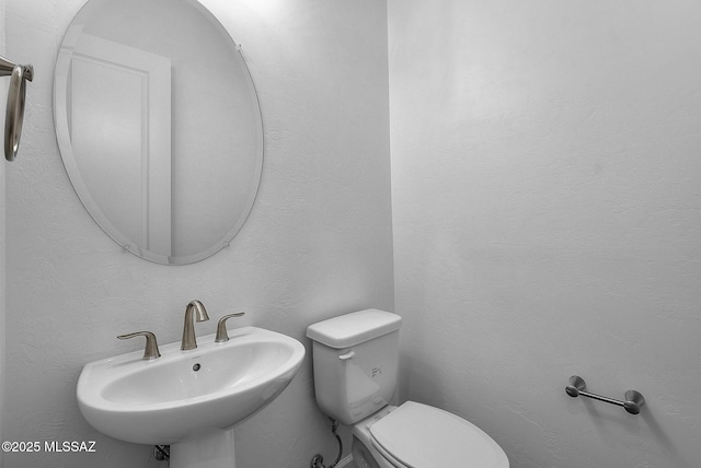 bathroom featuring sink and toilet