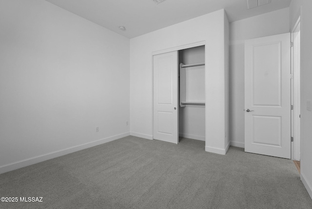 unfurnished bedroom featuring a closet and carpet floors
