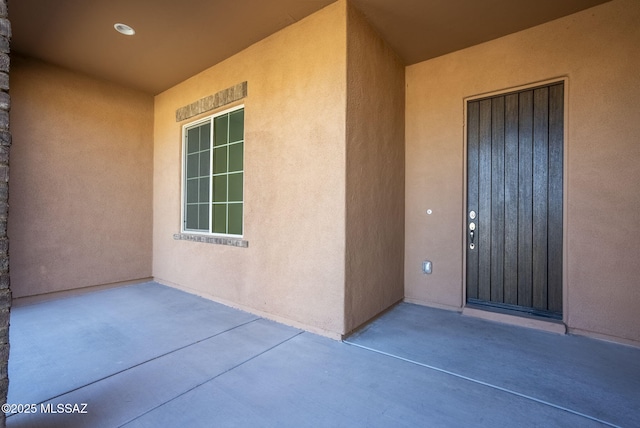 entrance to property featuring a patio area