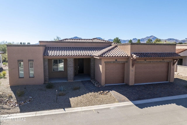 view of front of home with a mountain view and a garage