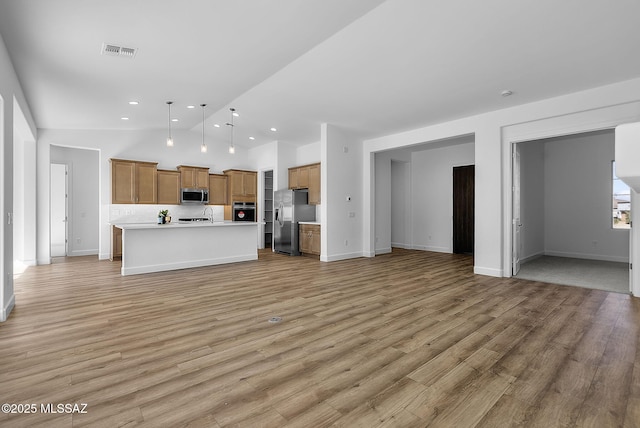 unfurnished living room with light hardwood / wood-style flooring and vaulted ceiling