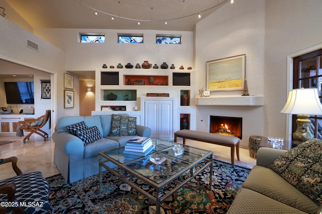 tiled living room with a towering ceiling