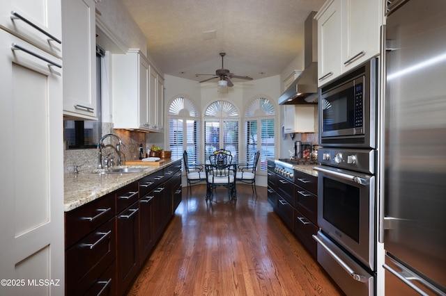 kitchen featuring backsplash, dark hardwood / wood-style floors, sink, stainless steel appliances, and white cabinets