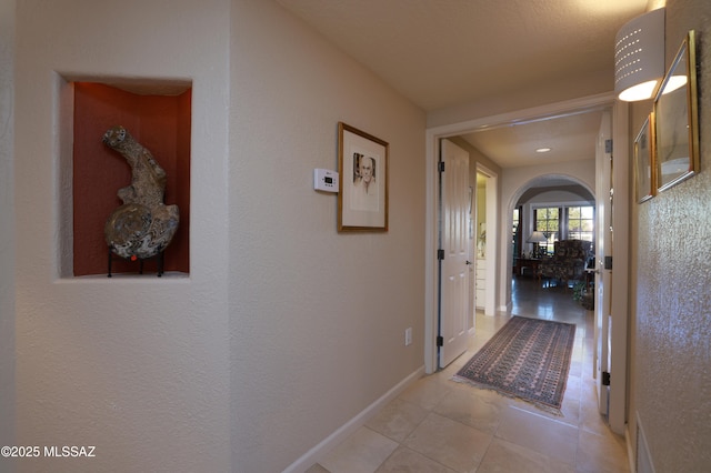 hallway featuring light tile patterned floors