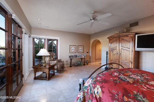 bedroom with ceiling fan and a textured ceiling