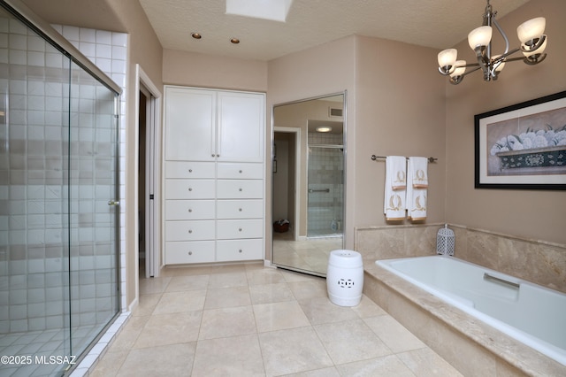 bathroom featuring tile patterned flooring, independent shower and bath, and an inviting chandelier