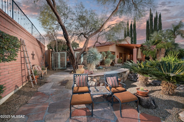 view of patio terrace at dusk