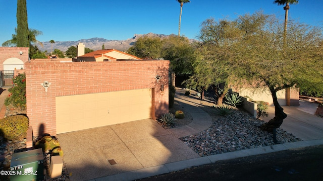 view of front of property featuring a garage and a mountain view