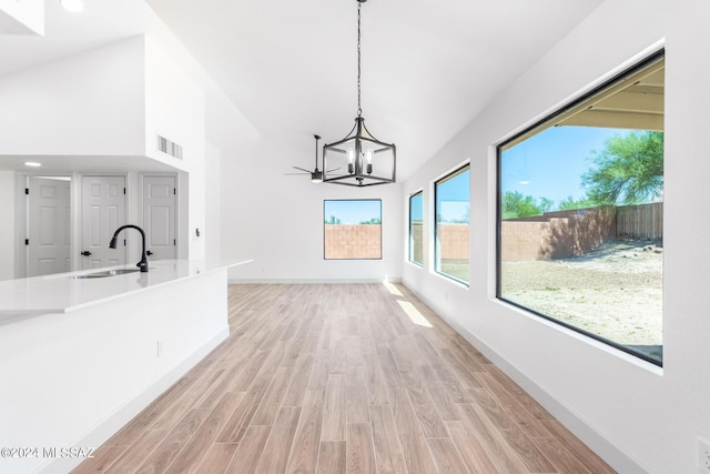 unfurnished dining area with a wealth of natural light, sink, and light hardwood / wood-style flooring