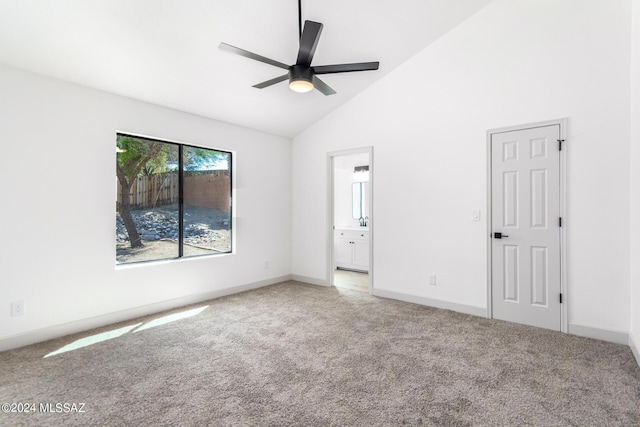 spare room featuring light carpet, ceiling fan, and high vaulted ceiling