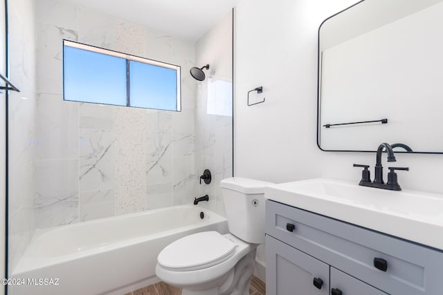 full bathroom featuring toilet, tiled shower / bath combo, and vanity