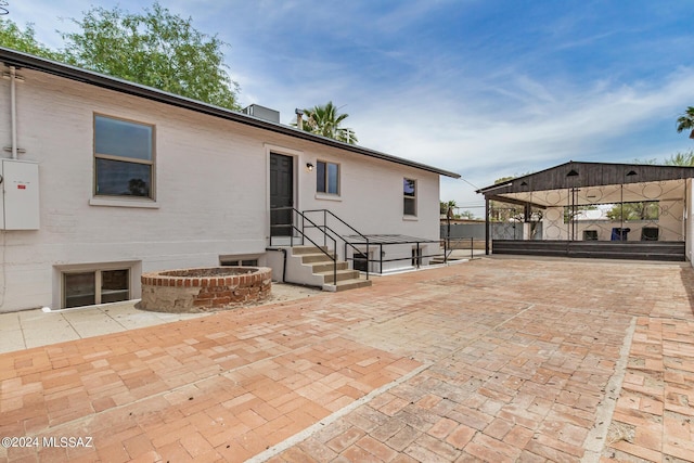 back of property featuring a gazebo and a patio