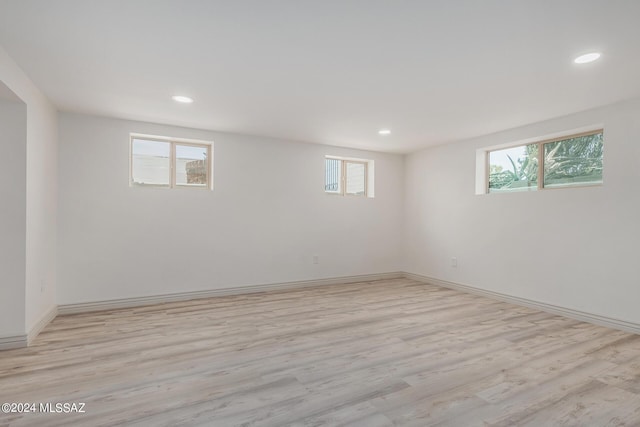 basement featuring light hardwood / wood-style floors and plenty of natural light