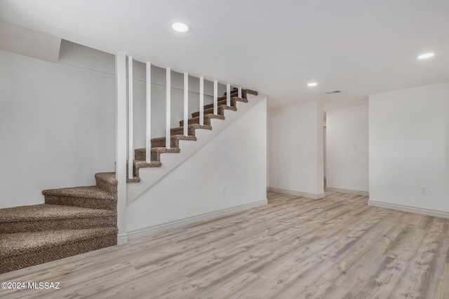 basement featuring light wood-type flooring