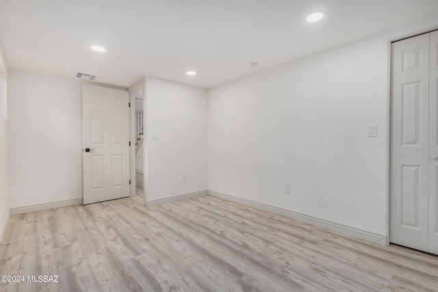 spare room with light hardwood / wood-style flooring