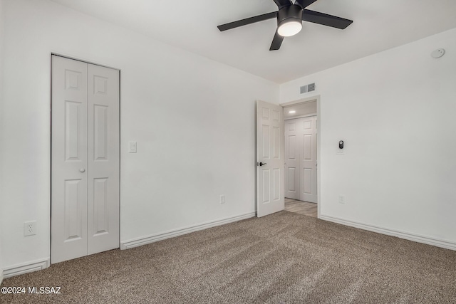 unfurnished room with ceiling fan and light carpet