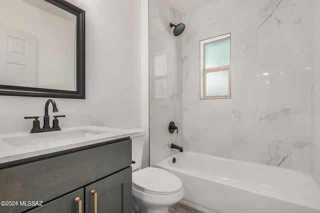 full bathroom featuring toilet, tiled shower / bath, and vanity