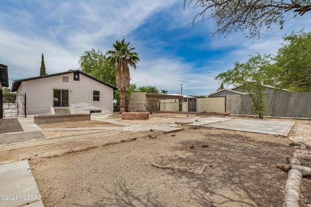 view of yard featuring an outdoor fire pit and a patio