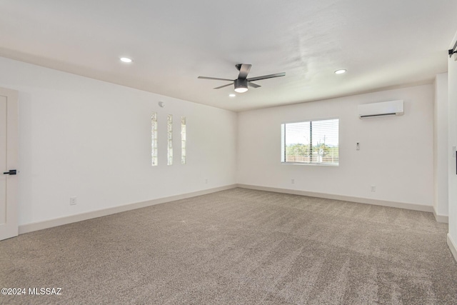 spare room with ceiling fan, carpet flooring, and a wall unit AC