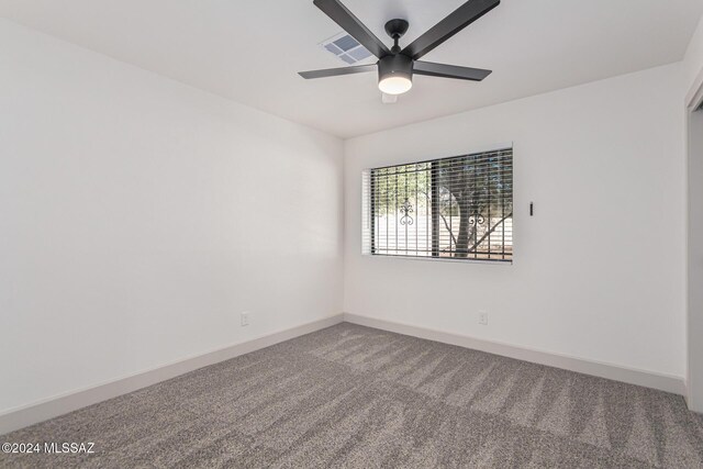 spare room featuring ceiling fan and carpet floors