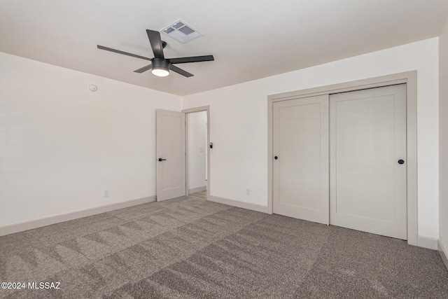 unfurnished bedroom featuring ceiling fan, a closet, and carpet floors