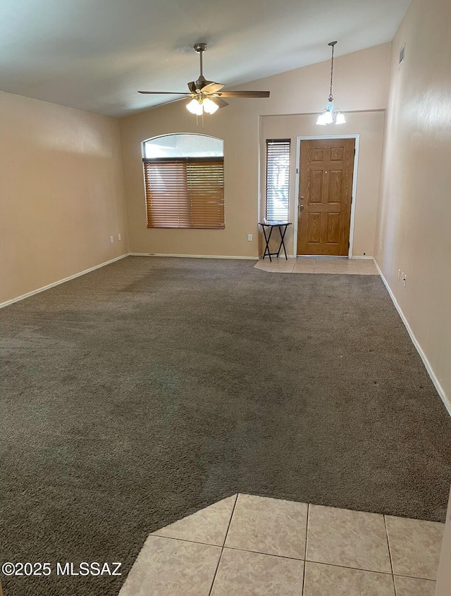 interior space featuring lofted ceiling, tile patterned floors, and ceiling fan