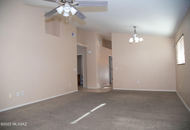 carpeted empty room with ceiling fan with notable chandelier and vaulted ceiling