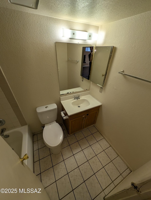 bathroom featuring vanity, toilet, tile patterned flooring, and a tub