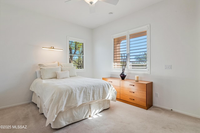 bedroom with ceiling fan and light carpet