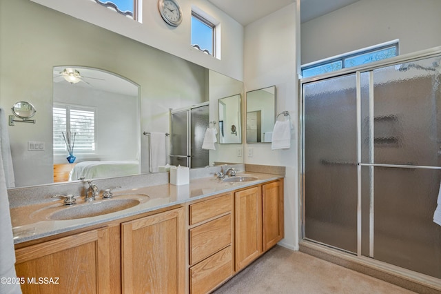 bathroom featuring an enclosed shower, ceiling fan, and vanity